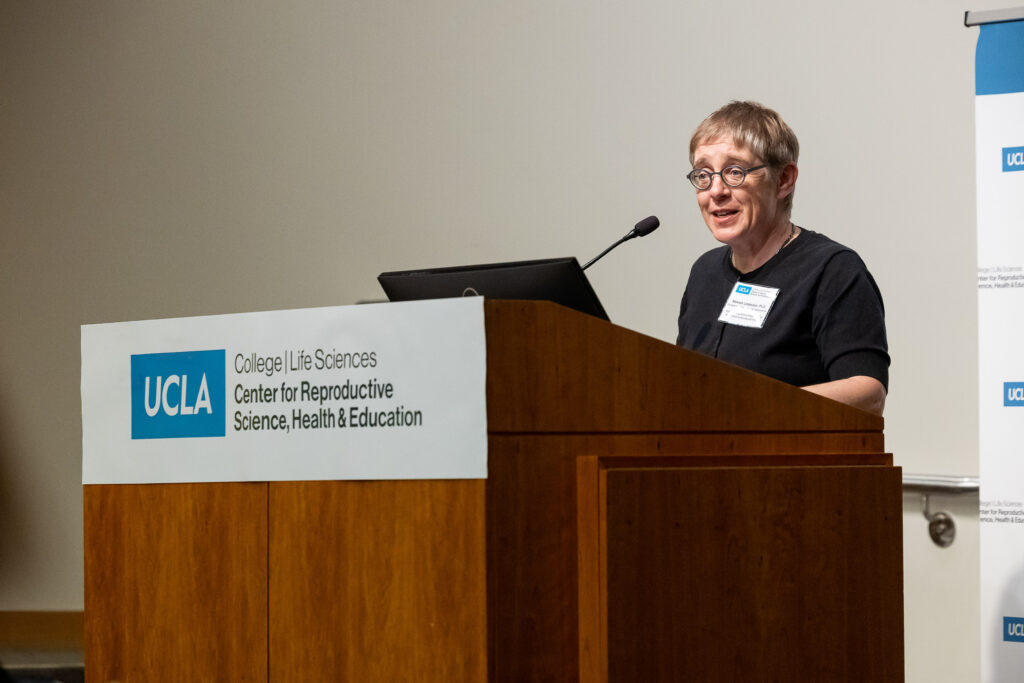 Hannah Landecker speaks at a UCLA podium during the CRSHE Distinguished