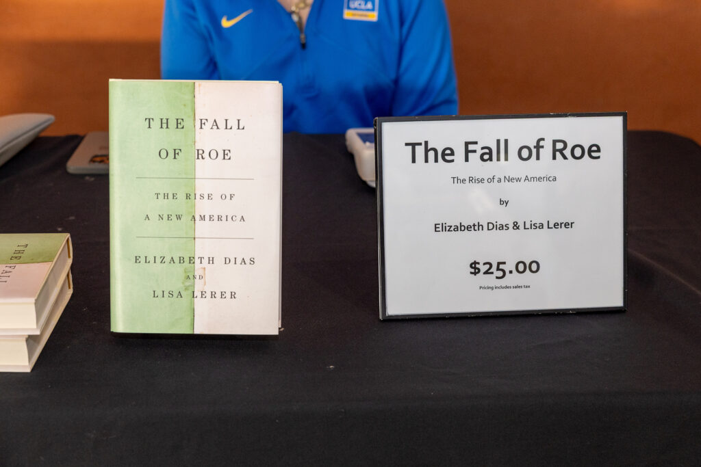 Two copies of "The Fall of Roe" by Elizabeth Dias and Lisa Lerer displayed at a book signing event for the CRSHE