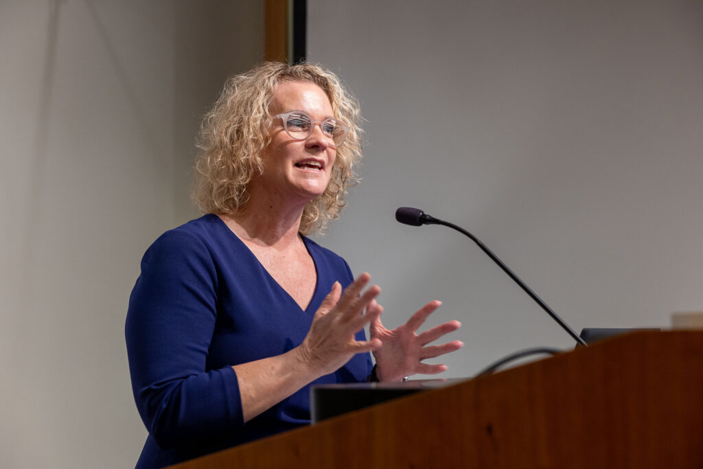 Speaker at a podium during a Distinguished Speaker Series event.