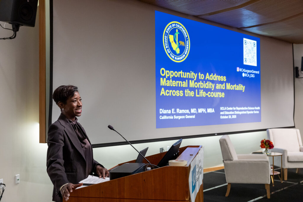 Tracy Johnson, Dean of Life Sciences, presents at a podium during a Distinguished Speaker Series event