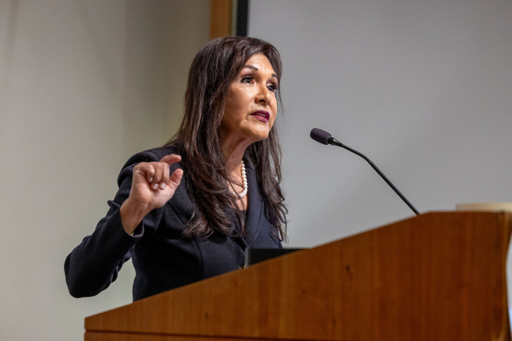 California Surgeon General Diana E. Ramos speaks at a podium during a Distinguished Speaker Series event.