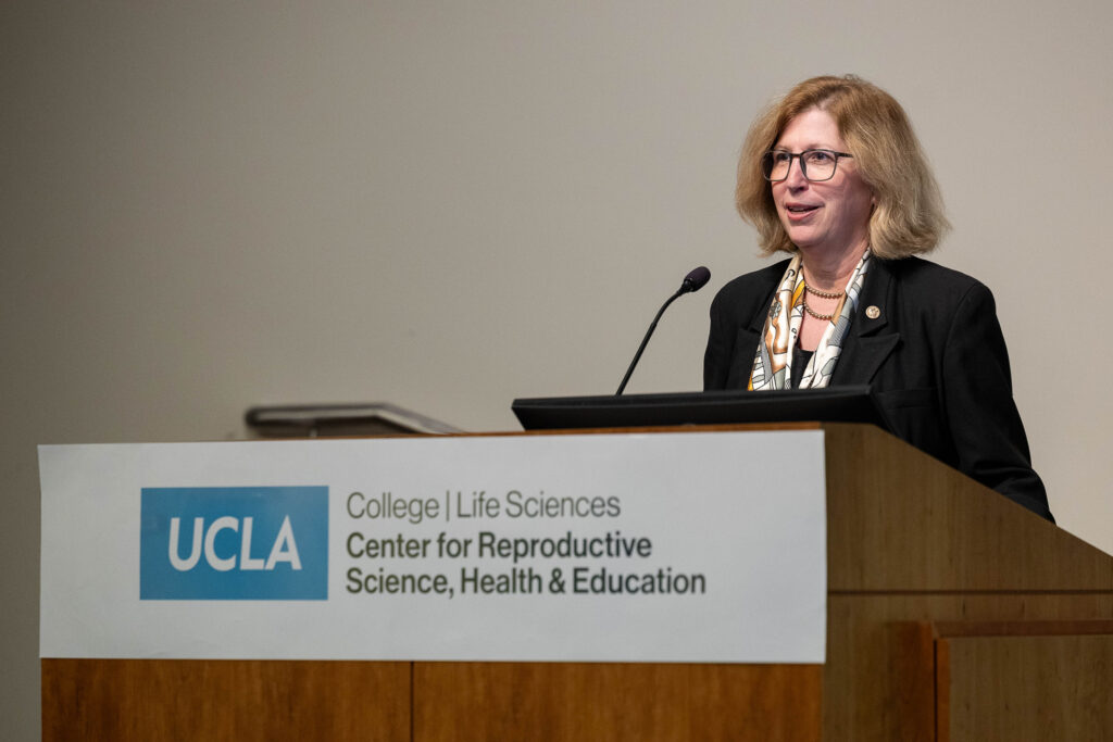 Dr. Teresa Woodruff speaks at a podium during the CRSHE Distinguished Speaker Series on Oncofertility.