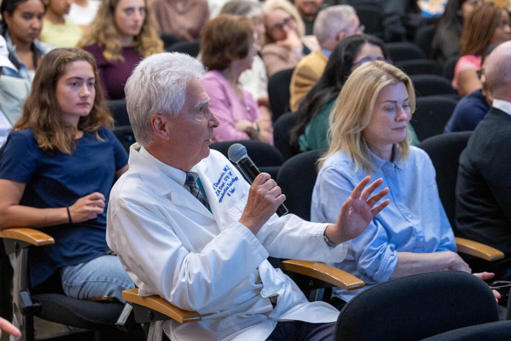 Audience members seated indoors listening attentively during the CRSHE Distinguished Speaker Series presentation by Dr.
