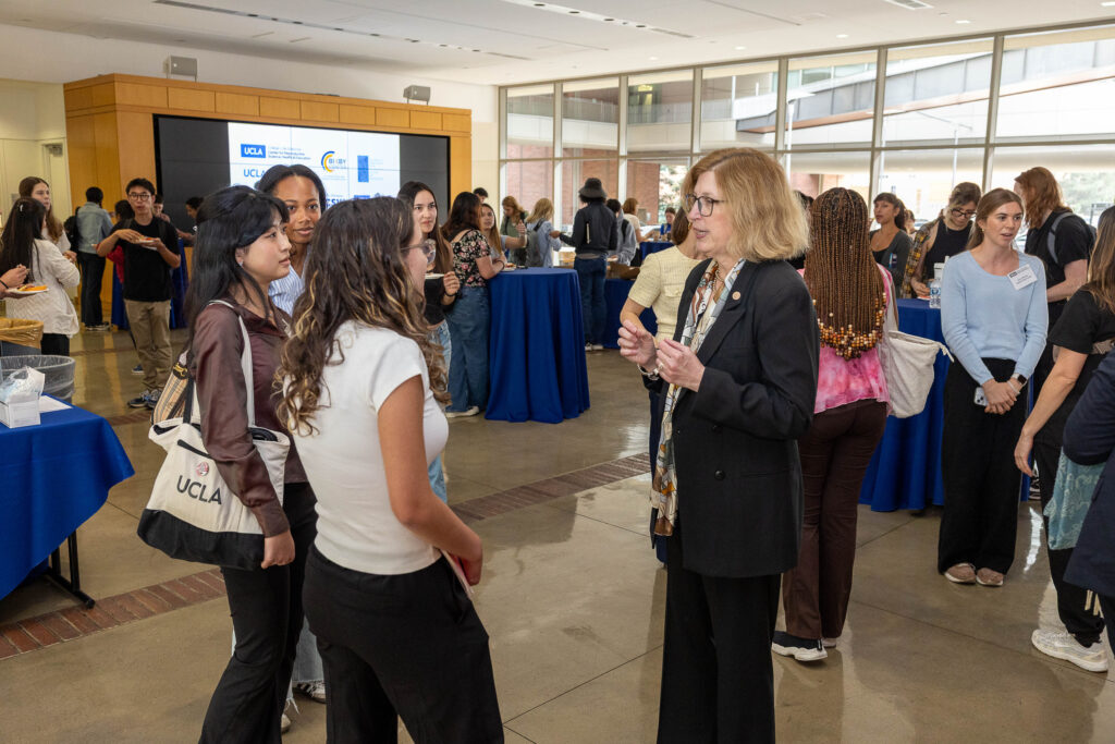 Attendees network at a CRSHE Distinguished Speaker Series event featuring Dr. Teresa Woodruff speaking on oncofertility